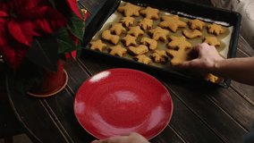 Preparing Christmas food. Woman puts homemade gingerbread cookies on a plate for Christmas - Powered by Shutterstock - Get 15% off with code: PIKWIZARD15