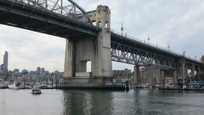 Gimbal panning shot of the Burrard Bridge over False Creek in Vancouver, British Columbia, Canada. 4K