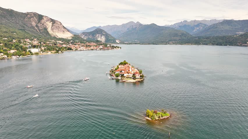 Aerial view showing Isola Bella with its baroque palace , also showing the surrounding lake, mountains, and coastal Italian towns in the distance, Stresa, VB, Piedmont, northern western Italy