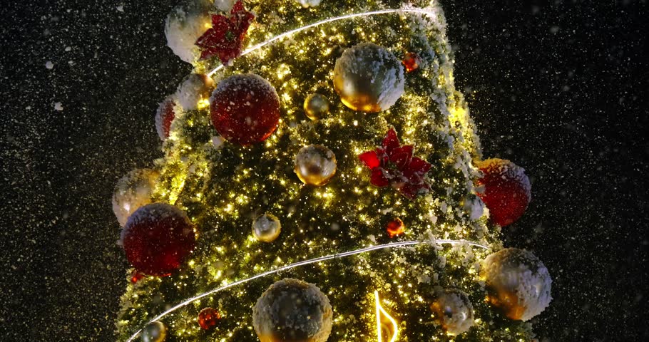 Close up of Christmas tree details with artificial red poinsettia flowers and golden balls covered in snow. Beautiful outdoor Xmas decorations glowing in the dark winter night.