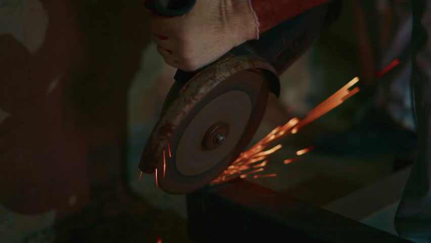 fabricator grinding steel beam with intense orange sparks, gloved hands guiding angle grinder along metal edge, workshop atmosphere, hot embers and flying particles, closeup - Powered by Shutterstock - Get 15% off with code: PIKWIZARD15