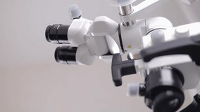 Male dental doctor using microscope in laboratory with protective gear for stomatology clinic. - Powered by Shutterstock - Get 15% off with code: PIKWIZARD15