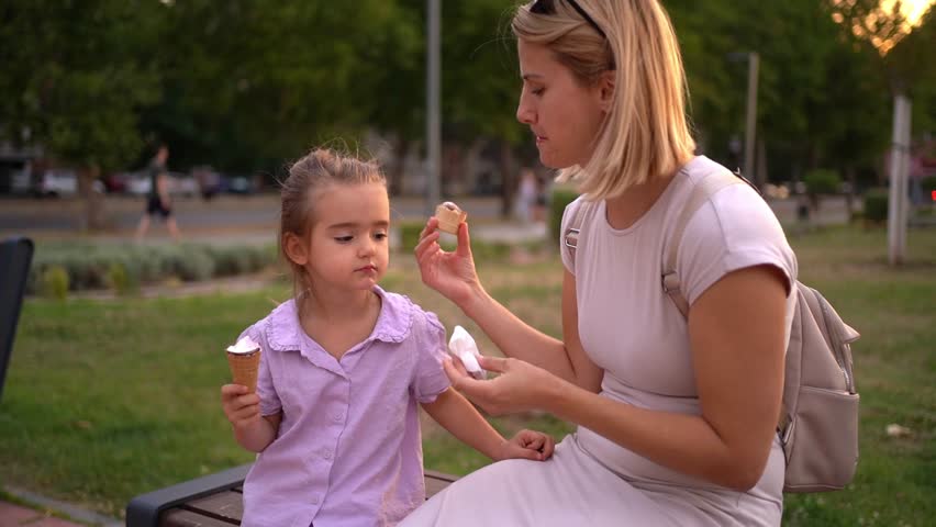 Mother cleaning daughter