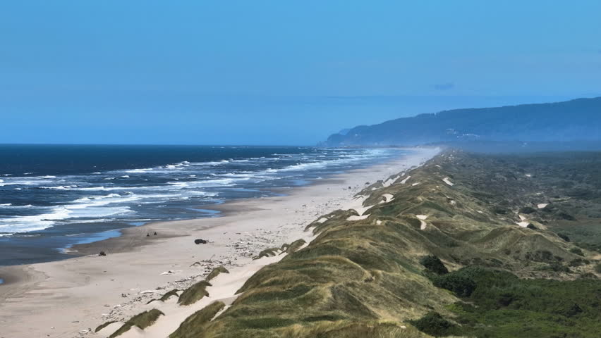 Aerial view around a long beach, on the coastline of Oregon, sunny day in USA