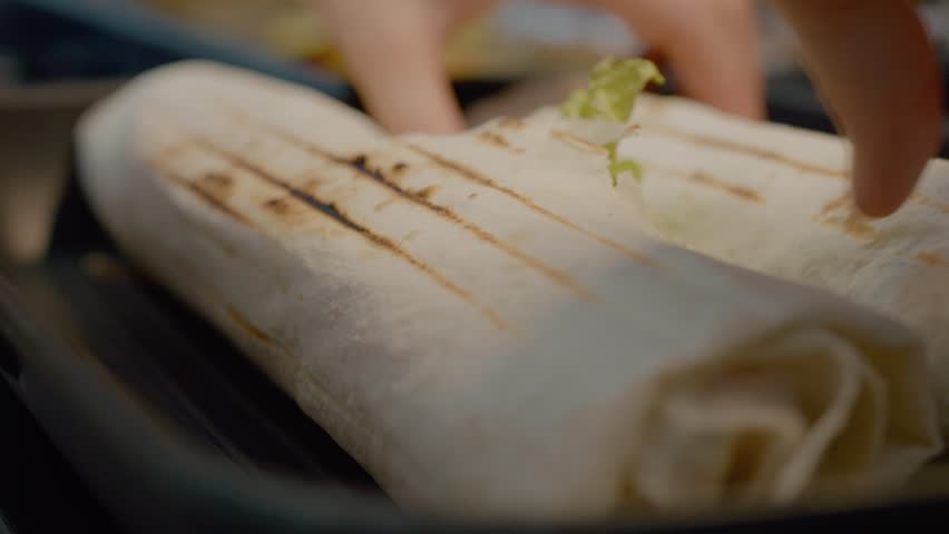 Watch as lavash kebabs are browned on a grill pan, showcasing the simple and delicious preparation of this flavorful dish.