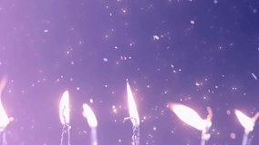 Celebratory Mood Slow Motion Candles Flicker Against a Sparkling Purple Backdrop. - Powered by Shutterstock - Get 15% off with code: PIKWIZARD15