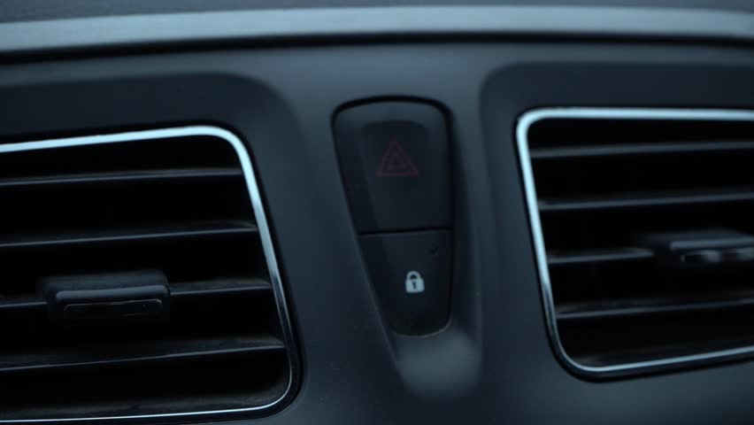 Close-up View of a Car Interior Control Panel Featuring Hazard Light and Lock Symbols with Air Vents, Capturing Functional Design Details and User Interaction. Video with sound.