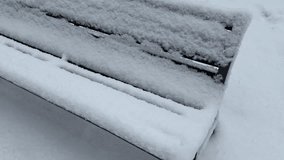 Close-up of a gloved hand touching thick fresh snow on a park bench in winter, concept of cold weather and tactile connection with nature - Powered by Shutterstock - Get 15% off with code: PIKWIZARD15