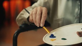 Close-up of senior woman artist painting picture on easel stand, art therapy - Powered by Shutterstock - Get 15% off with code: PIKWIZARD15