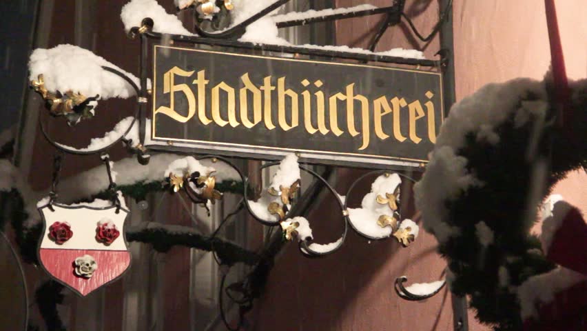 The Signboard of the City Library in the Snow, the Coat of Arms of the city in the Snow, Heavy Snowfall in Moosburg an der Isar, Germany, Bavaria, 1 December 2023