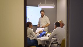 Business colleagues participate in a dynamic meeting, where a presenter explains complex data on a screen. Their collaborative discussion aims to analyze contributions and develop future strategies. - Powered by Shutterstock - Get 15% off with code: PIKWIZARD15