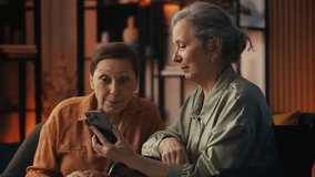 Two smiling senior women friends discussing shopping deals in online store - Powered by Shutterstock - Get 15% off with code: PIKWIZARD15