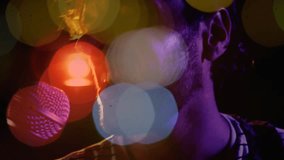 Male singer opening mouth and singing into mic during music set, colored bokeh obscuring face. Stage, club, spotlight, microphone, vocal, performance, lensflare - Powered by Shutterstock - Get 15% off with code: PIKWIZARD15