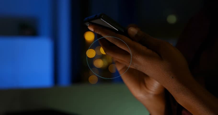 Woman holding phone and tapping, initiating circular HUD expanding and locking for technology demo. Smartphone, holographic, interface, concentric, gesture, nocturnal, promo