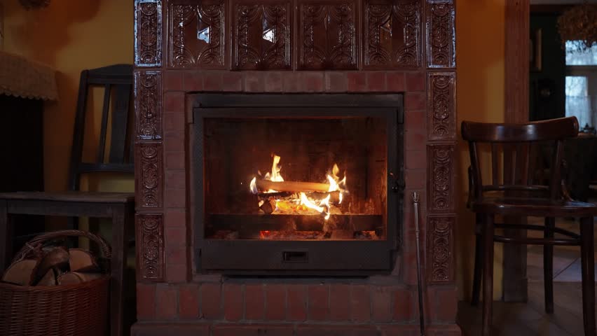 Wood burning in the fireplace in the interior of old European house