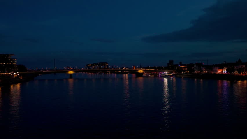 Cityscape of The Rhine River and bridge at night in Cologne, Germany