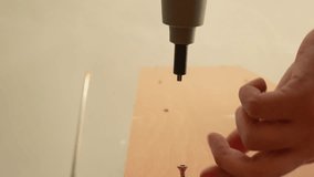 Close-Up of Cordless Drill Driving Screw into Wood Panel - Powered by Shutterstock - Get 15% off with code: PIKWIZARD15