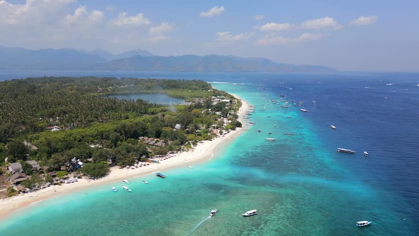 Aerial view of Gili Meno, Indonesia, with tropical coastline, turquoise water, and tropical resorts. Scenic travel destination near Lombok.