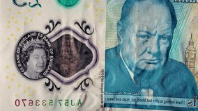 Close up stop motion animation sequence of different British pound sterling banknotes The video represents concepts of finance, banking, and the UK economy - Powered by Shutterstock - Get 15% off with code: PIKWIZARD15