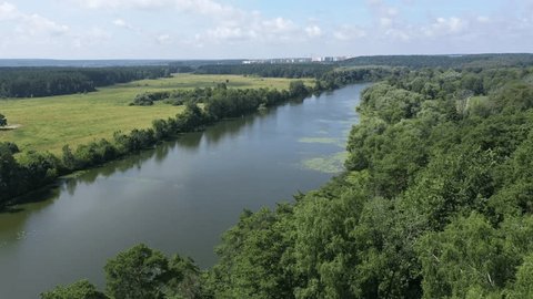 Drone Flying above Calm River Cutting through