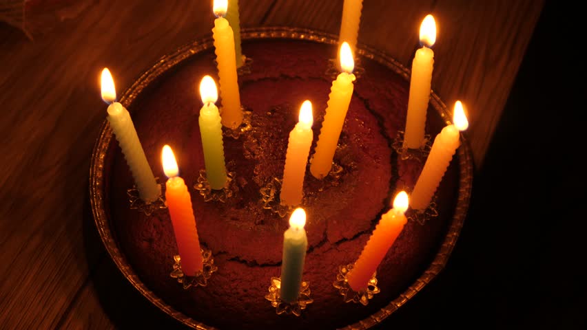 A birthday cake with candles lights burning on top of it