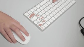 A wide shot showcasing both hands actively using a sleek white wireless mouse and keyboard on a gray office desk. The scene represents dual tasking, fast computing, and efficient modern work. - Powered by Shutterstock - Get 15% off with code: PIKWIZARD15