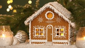 Beautiful gingerbread house and Christmas decor on table against blurred lights, closeup. Bokeh effect - Powered by Shutterstock - Get 15% off with code: PIKWIZARD15