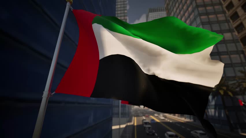 United Arab Emirates national flag waving along a modern city street under clear daylight, surrounded by buildings, palm trees and light traffic within an urban environment. This vibrant banner features the traditional pan-Arab colors, with a vertical red band at the hoist and horizontal stripes of green, white, and black flying freely. The textile ripples gracefully in the breeze, showcasing the emblem of the seven sheikhdoms against a backdrop of architectural marvels. Behind the ensign, a bustling metropolis comes to life with glass-fronted towers and high-rises typical of Dubai or Abu Dhabi. The bright sunshine illuminates the fabric, casting dynamic shadows across the folds of the material. Palm trees lining the boulevard add a touch of nature to the concrete jungle, creating a harmonious blend of tradition and modernity. Vehicles move steadily on the asphalt, hinting at the industrious rhythm of this Middle Eastern hub. This footage is perfect for projects related to UAE National Day, celebrated on December 2nd, or content focusing on Gulf cooperation. The standard symbolizes pride and sovereignty, making it an ideal visual for diplomatic news or travel documentaries exploring the Arabian Peninsula. As the subject undulates, the woven cloth catches the solar rays, highlighting the vivid saturation of each hue. Observers can appreciate the detailed texture of the nylon against the azure firmament. The scene captures the essence of a rapidly developing economy, grounded in rich heritage yet reaching for the future. The fluttering pendant serves as a constant reminder of identity amidst the towering skyscrapers. Use this clip to illustrate themes of governance, international relations, or regional tourism in the Persian Gulf. The composition balances the foreground object with the depth of the cityscape, providing a versatile asset for professional editors requiring high-quality daylight stock.