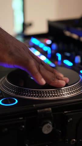 DJ mixing on a turntable at a club