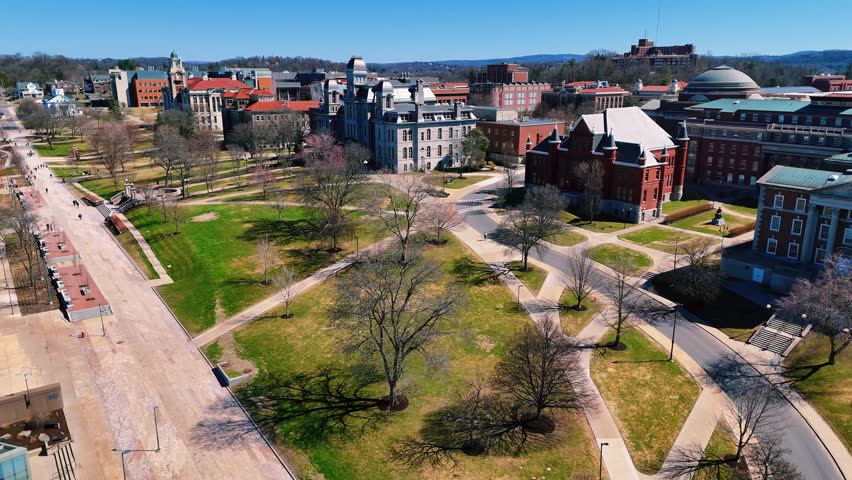Ascending over a college campus in the incipience of spring capturing the well-planned design of it and the educational buildings it possesses