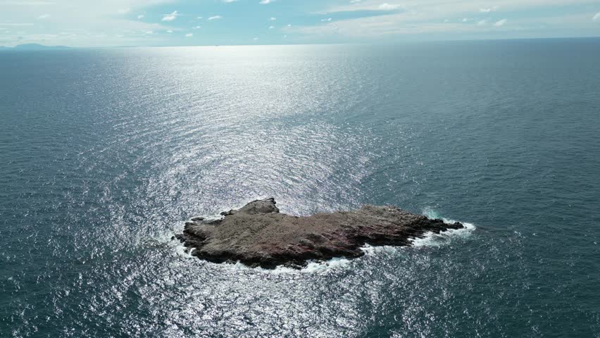 A lonely, flat island floating in the middle of the sea, a bird island, a bird
