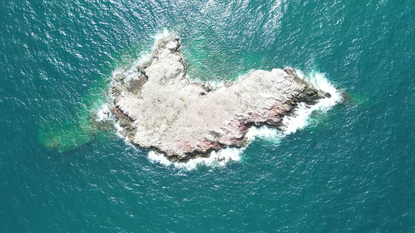A lonely, flat island floating in the middle of the sea, a bird island, a bird