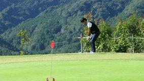 A middle-aged Japanese man enjoying golf - Powered by Shutterstock - Get 15% off with code: PIKWIZARD15
