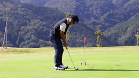 A middle-aged Japanese man enjoying golf - Powered by Shutterstock - Get 15% off with code: PIKWIZARD15