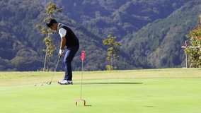A middle-aged Japanese man enjoying golf - Powered by Shutterstock - Get 15% off with code: PIKWIZARD15
