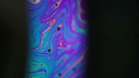 Spectrum ink fluid. Rainbow arch. Colorful round lens paint mix dye on black background. Blue purple green night blur abstract flow. - Powered by Shutterstock - Get 15% off with code: PIKWIZARD15