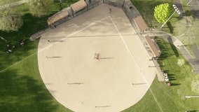 Aerial drone view of kids playing baseball at a park on a sunny day, showcasing youth sports, outdoor activity, teamwork, and recreational fun in a vibrant setting. - Powered by Shutterstock - Get 15% off with code: PIKWIZARD15