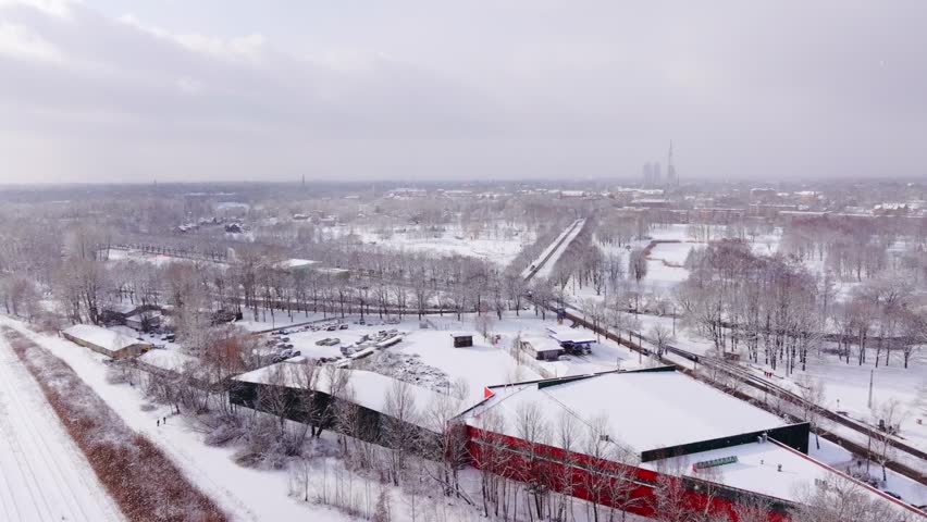 Bright sun breaks through heavy snowstorm over snowy Victory Park in Riga