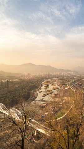 Beijing Yongding River wetlands at dusk — autumn scenery blending urban and natural landscapes for a calming, restorative view