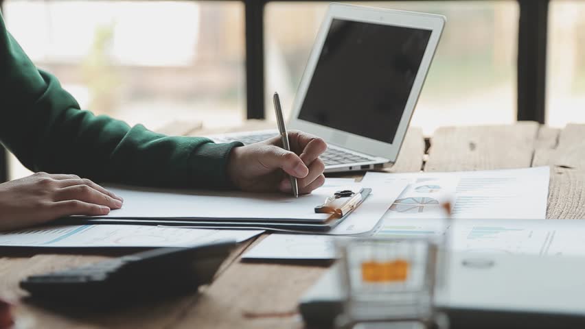 Hands, person and typing on laptop with graphs documents, data analysis and financial report. Accountant, paperwork for finance growth, investment statistics. bookkeeping. book Notebook paper writing - Powered by Shutterstock - Get 15% off with code: PIKWIZARD15