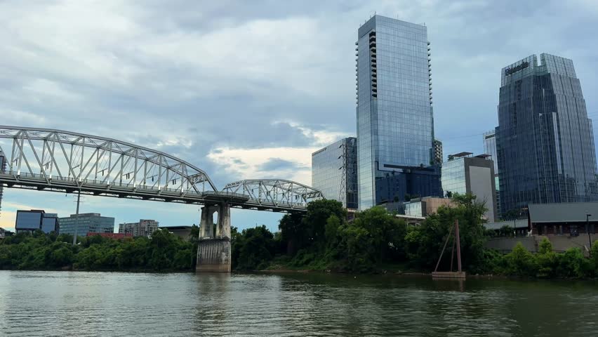 Scenic view of the John Seigenthaler Pedestrian Bridge in Nashville, Tennessee, framed by the Cumberland River and the city