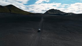 4x4 convoy driving across Fjallabak’s dark volcanic desert under shifting clouds, surrounded by rugged peaks and Iceland’s remote highland scenery. - Powered by Shutterstock - Get 15% off with code: PIKWIZARD15