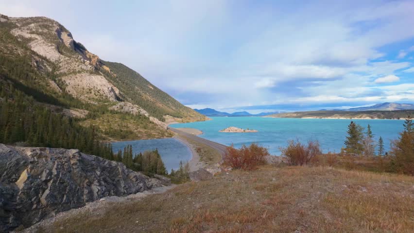 Hillside View Of Road, Lake And Sky At Abraham Lake