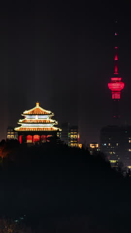 Beijing, China, illuminated Wanchun Pavilion on Jingshan and the CCTV Tower, showcasing the cityscape