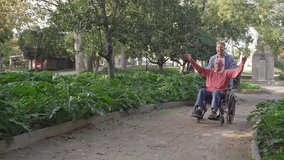 Grandson running and pushing joyful elderly man in wheelchair with arms up in a park - Powered by Shutterstock - Get 15% off with code: PIKWIZARD15