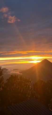 Sunrise in Guatemala on top of a volcano as the sun rises above volcano. Acatenango to tge right. 