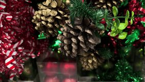 Christmas decorations featuring pinecones, greenery, red candy-striped tinsel, and bright holiday lights - Powered by Shutterstock - Get 15% off with code: PIKWIZARD15