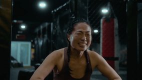 Japanese female MMA fighter kneels in the cage with arms raised, smiling and celebrating victory, a powerful moment of confidence, joy and champion spirit. - Powered by Shutterstock - Get 15% off with code: PIKWIZARD15
