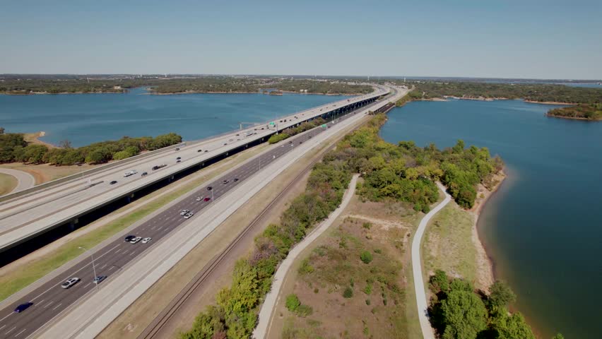 Aerial flight over highway I35E over Lake Lewisville in Texas.