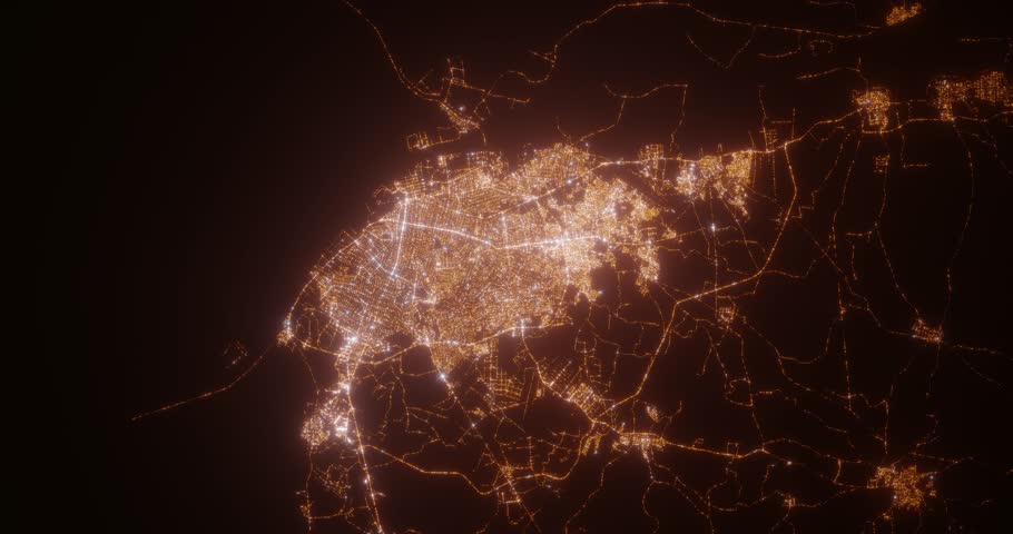 Barranquilla (Colombia) aerial view at night. Top view on modern city with street lights. Camera is zooming out, rotating counterclockwise. Vertical video. The north is on the left side